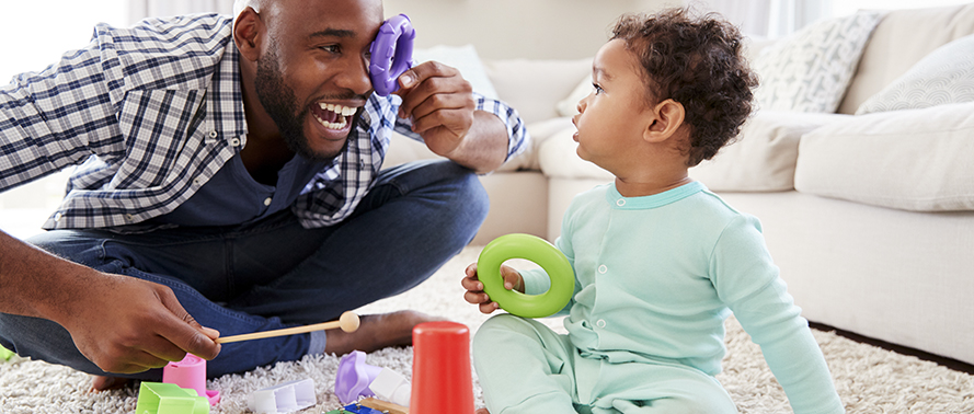 Becoming Playful Parents - Dad playing with his baby