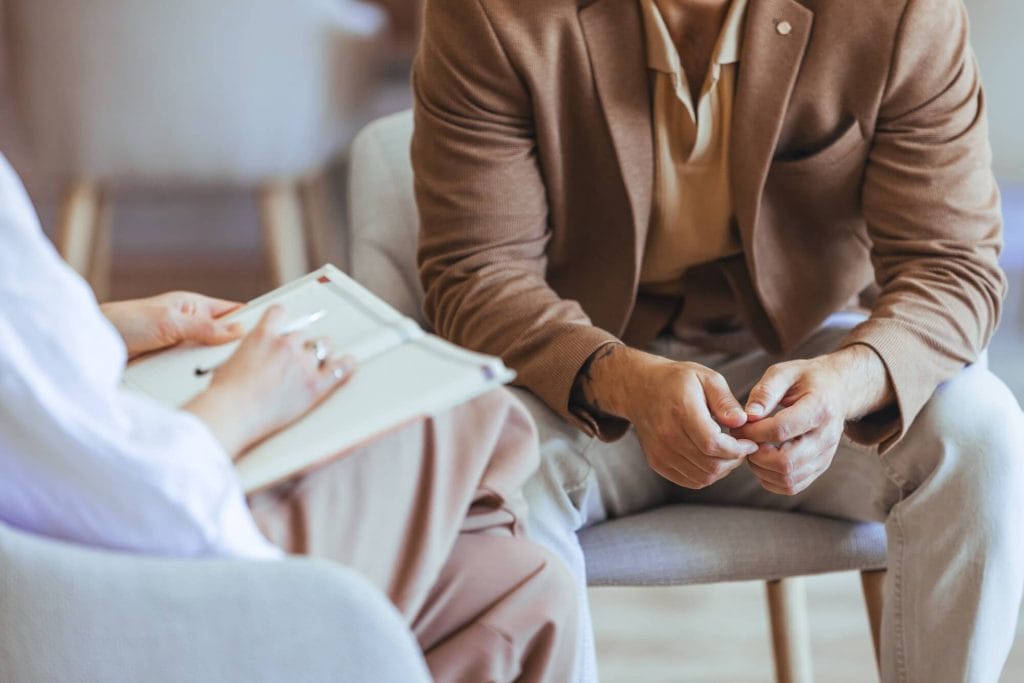 Client speaking with a therapist during an in-person counseling session at Wellspring Center for Counseling in Mt. Zion, Illinois.